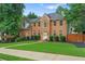 Charming two-story brick home with a well-manicured lawn at 200 Creek Run Ct, Alpharetta, GA 30005