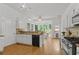 Bright kitchen with white cabinetry, modern appliances, and a sun-drenched breakfast nook at 200 Creek Run Ct, Alpharetta, GA 30005