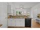 White kitchen offering ample counter space, modern appliances, and a view of the breakfast nook at 200 Creek Run Ct, Alpharetta, GA 30005