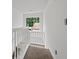 Upstairs landing featuring carpet and a window with neighborhood views allowing for natural light at 200 Creek Run Ct, Alpharetta, GA 30005