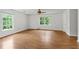 Spacious living area featuring hardwood floors and large windows providing ample light at 200 Creek Run Ct, Alpharetta, GA 30005