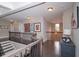 Bright upper hallway with hardwood floors, elegant staircase, and stylish decor, providing a welcoming ambiance at 2720 Garonne Way, Cumming, GA 30041