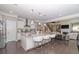Modern kitchen with white cabinets, granite countertops, stainless steel appliances, and an open view to the living area at 2720 Garonne Way, Cumming, GA 30041