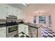 Compact kitchen with stainless steel appliances and checkered flooring at 2867 Holly Oaks Dr, Marietta, GA 30062