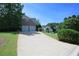 A long driveway leads to a two-car garage on a sunny day at 3071 Intrepid Wake, Marietta, GA 30062