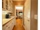 Hallway featuring detailed trim, a butlers pantry, hardwood flooring, and views into adjacent rooms at 3071 Intrepid Wake, Marietta, GA 30062