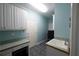 Laundry room with custom cabinets, utility sink, and access to the exterior at 3071 Intrepid Wake, Marietta, GA 30062