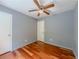 Bedroom with hardwood floors, ceiling fan, and doorways at 4728 Garden Hills Dr, Stone Mountain, GA 30083