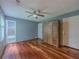 Bedroom with hardwood floors, ceiling fan, and open doorway at 4728 Garden Hills Dr, Stone Mountain, GA 30083