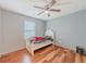 Bedroom with hardwood floors, ceiling fan, window, and a twin bed at 4728 Garden Hills Dr, Stone Mountain, GA 30083