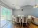 Cozy dining area with a door to the patio, hardwood floors, and decorative lighting at 4728 Garden Hills Dr, Stone Mountain, GA 30083
