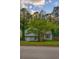 Charming two-story home features a well-maintained lawn and mature tree in front, with curb appeal at 4728 Garden Hills Dr, Stone Mountain, GA 30083