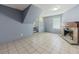 Open living room with fireplace and staircase featuring tile flooring, window, and light-colored paint at 4728 Garden Hills Dr, Stone Mountain, GA 30083