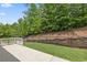 Backyard with a concrete patio, grass, and a chain link fence at 1220 Roswell Manor Cir, Roswell, GA 30076