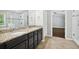 Bathroom featuring granite countertops, dual sinks, tiled floors, and a glass shower at 1220 Roswell Manor Cir, Roswell, GA 30076