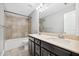 Bathroom featuring dual sink vanity, combination tub and shower, and neutral color palette at 1220 Roswell Manor Cir, Roswell, GA 30076