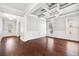 Elegant dining area showcasing hardwood floors, wainscoting, coffered ceilings, and stylish lighting at 1220 Roswell Manor Cir, Roswell, GA 30076
