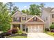 Charming brick two-story home with manicured landscaping and a three-car garage at 1220 Roswell Manor Cir, Roswell, GA 30076