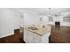 Kitchen island features a stainless sink and faucet, granite countertops, and white cabinets at 1220 Roswell Manor Cir, Roswell, GA 30076