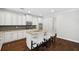 Bright kitchen features white cabinets, granite countertops, stainless appliances, and a center island with seating at 1220 Roswell Manor Cir, Roswell, GA 30076