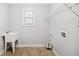 Laundry room with white sink, venetian blinds, and a wire shelf at 1220 Roswell Manor Cir, Roswell, GA 30076