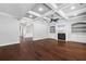 Open-concept living room features coffered ceilings, hardwood floors, built-in shelving and a fireplace at 1220 Roswell Manor Cir, Roswell, GA 30076