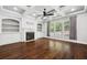 Living room with hardwood floors, coffered ceilings, built-in shelving and a fireplace at 1220 Roswell Manor Cir, Roswell, GA 30076