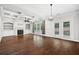 Open-concept living room features coffered ceilings, hardwood floors, built-in shelving and a fireplace at 1220 Roswell Manor Cir, Roswell, GA 30076