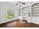 Spacious office with hardwood floors, a large window, and custom-built shelving at 1220 Roswell Manor Cir, Roswell, GA 30076