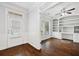 Bright home office featuring hardwood floors, built-in shelving, and wainscoting details at 1220 Roswell Manor Cir, Roswell, GA 30076