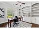 Home office space showcasing custom built-in shelves and a modern desk setup at 1220 Roswell Manor Cir, Roswell, GA 30076