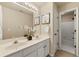 Bright bathroom featuring double sinks, white cabinets, framed artwork, and shower tub combination at 1995 Settindown Dr, Roswell, GA 30075