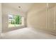 Spacious bedroom featuring neutral walls, carpet, and large window offering plenty of natural light at 1995 Settindown Dr, Roswell, GA 30075