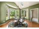 Bright dining area with large windows, a skylight, and a stylish chandelier at 1995 Settindown Dr, Roswell, GA 30075