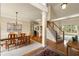 Open dining area featuring wood floors, carpet, staircase and ample light from large windows at 1995 Settindown Dr, Roswell, GA 30075