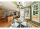 Bright dining area featuring a skylight, views to a deck, and open to the kitchen at 1995 Settindown Dr, Roswell, GA 30075