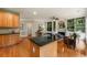 Open-concept kitchen with island and view into the living room with fireplace and built-ins at 1995 Settindown Dr, Roswell, GA 30075