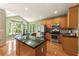 Modern kitchen with stainless steel appliances, granite countertops, and adjacent breakfast nook at 1995 Settindown Dr, Roswell, GA 30075