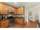 Well-equipped kitchen with stainless steel appliances and wooden cabinets at 1995 Settindown Dr, Roswell, GA 30075