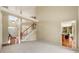 Bright and spacious living room with high ceilings and staircase to upper level at 1995 Settindown Dr, Roswell, GA 30075