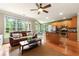 Open concept living area flowing into kitchen with hardwood floors and large windows offering natural light at 1995 Settindown Dr, Roswell, GA 30075