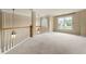 Spacious loft area with fresh carpet, large windows, and natural lighting at 1995 Settindown Dr, Roswell, GA 30075