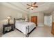 Main bedroom featuring a tray ceiling, ceiling fan, and ensuite access at 1995 Settindown Dr, Roswell, GA 30075