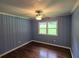 Cozy bedroom featuring hardwood floors, beadboard wall panels, ceiling fan and a large window at 2217 Sargent Se Pl, Atlanta, GA 30315