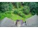 Expansive backyard with mature trees, a deck with a covered area, and lush greenery for outdoor enjoyment at 2440 Weatherford Ct, Marietta, GA 30068