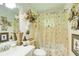 Charming bathroom with floral accents, vanity, and decorative shower curtain; creates a warm atmosphere at 2440 Weatherford Ct, Marietta, GA 30068
