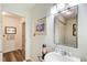 Bathroom features a pedestal sink, decorative fixtures, and a large mirror at 2440 Weatherford Ct, Marietta, GA 30068