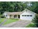 Charming single-story home with white siding, a well-manicured lawn, and an attached two-car garage at 2440 Weatherford Ct, Marietta, GA 30068