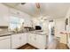 Bright kitchen features white cabinets, wood flooring, and a view to an open floor plan at 2440 Weatherford Ct, Marietta, GA 30068