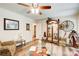 Spacious living room with a ceiling fan, hardwood floors, and many decorative items at 2440 Weatherford Ct, Marietta, GA 30068